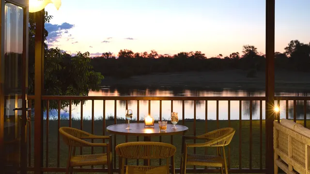 Lounge and dining deck overlooking the waterhole at Arathusa Safari Lodge